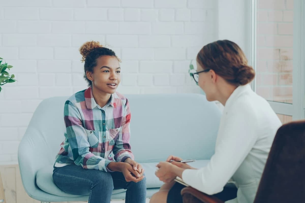 A clinician and young person in a therapy session