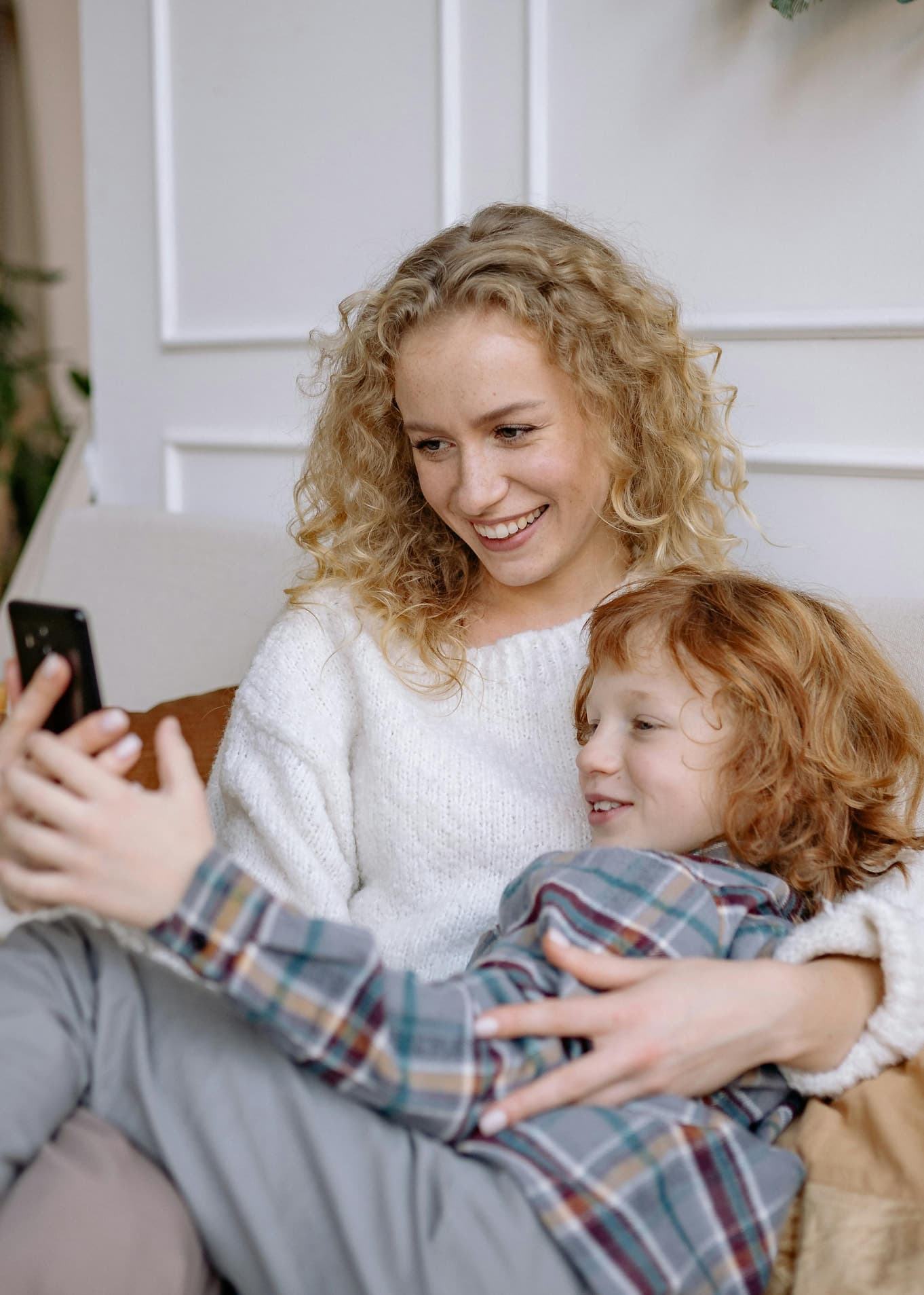 A parent and young child sharing a happy moment at home
