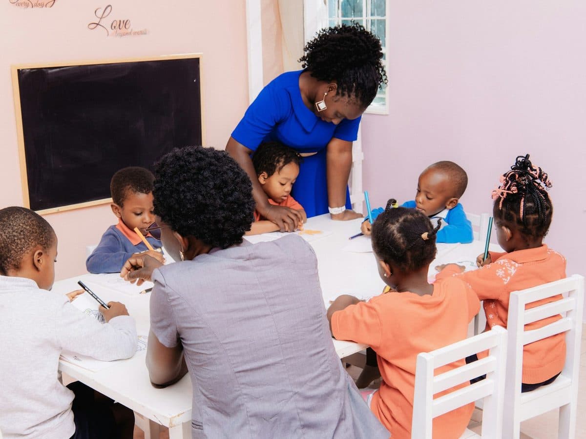 A practitioner working with a group of children at a table