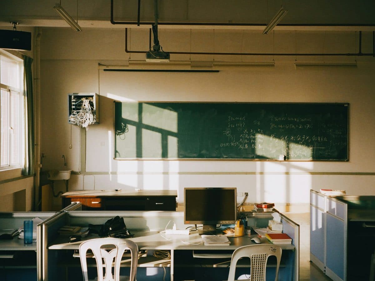 Sunlight across an empty classroom with a blackboard