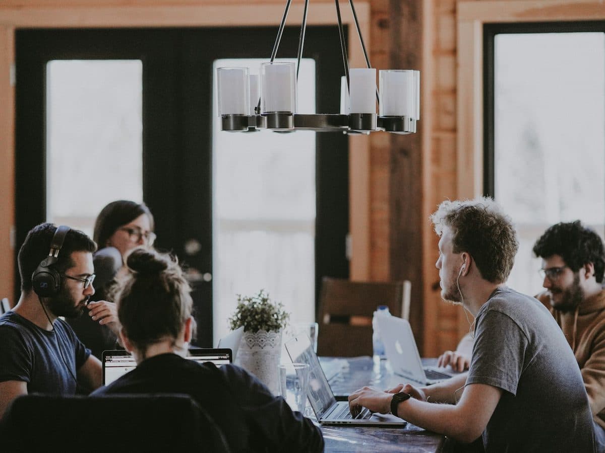 A team working around a table in a warm, wood-lined room