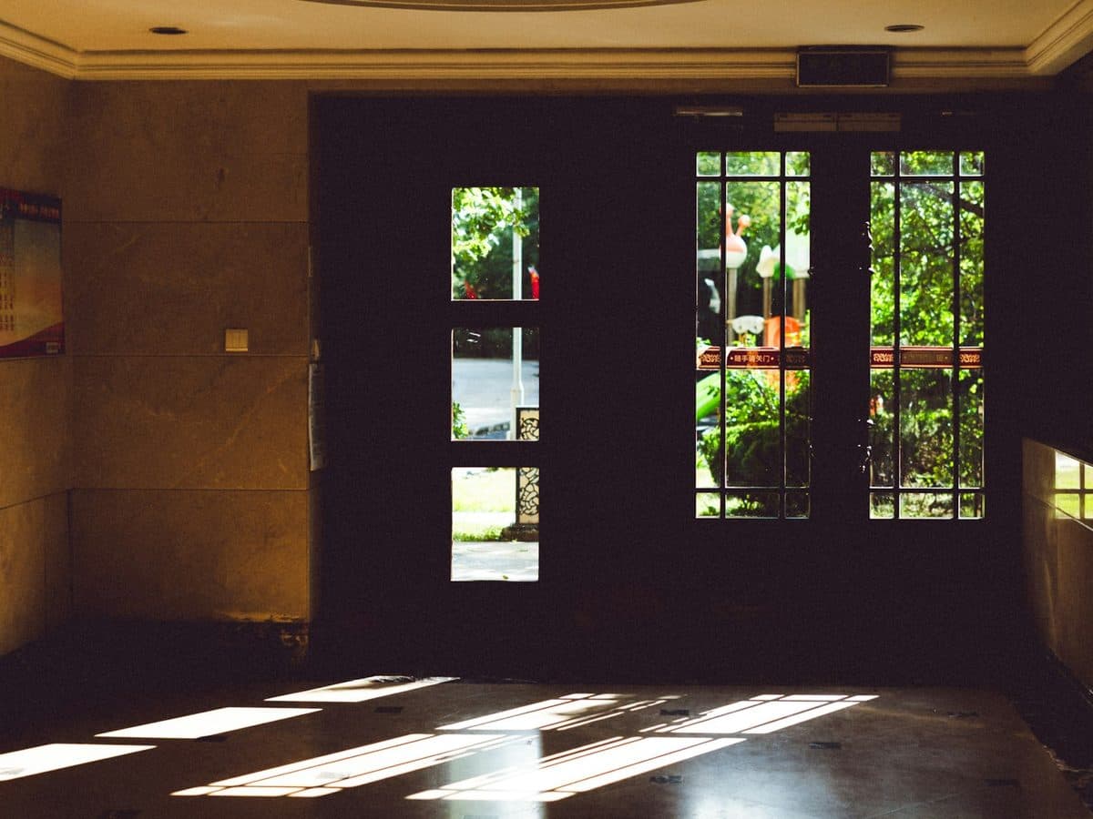 Sunlight falling through a doorway onto the floor of a warm hallway