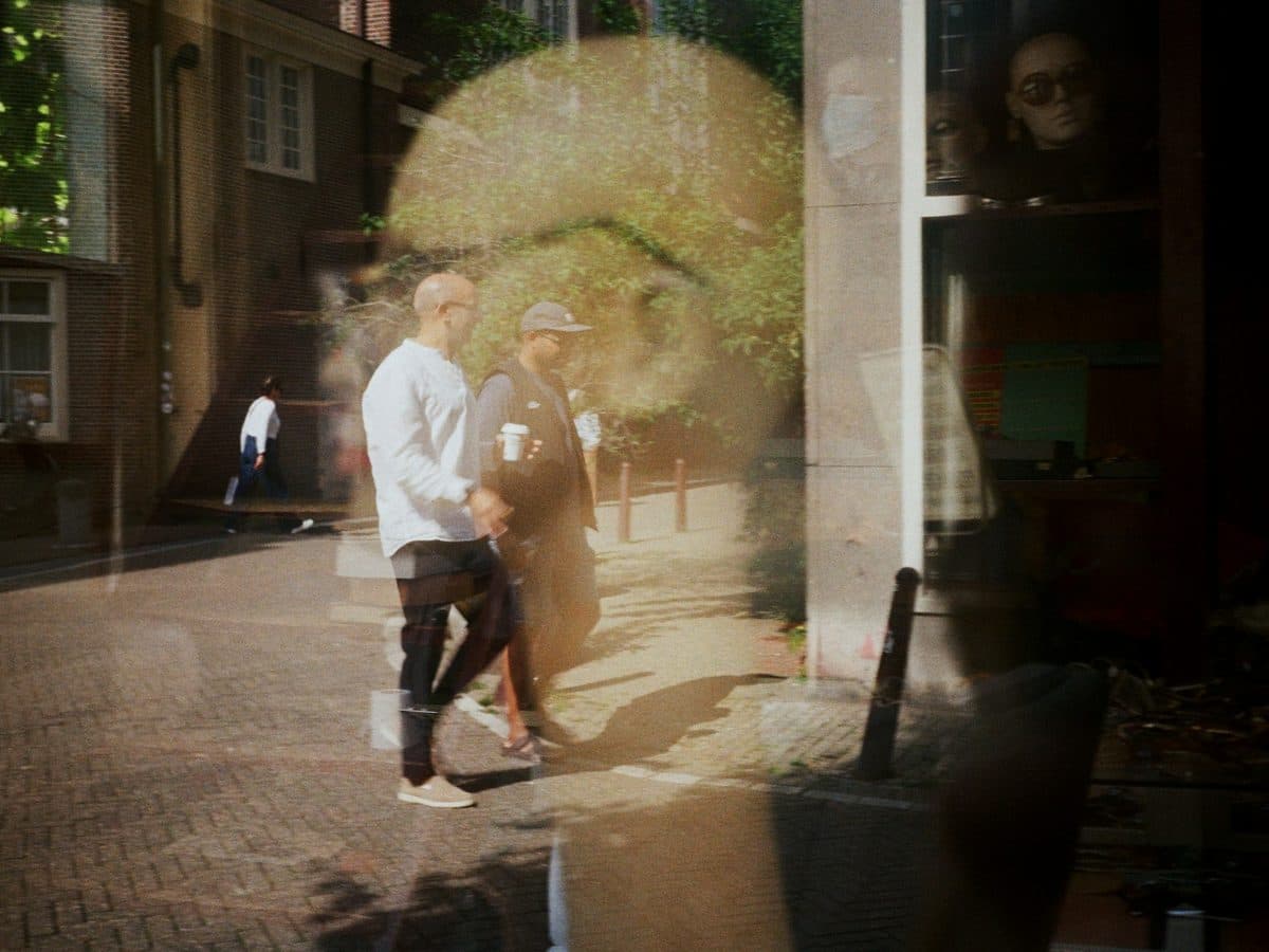 Two street scenes layered over one another in a single window reflection